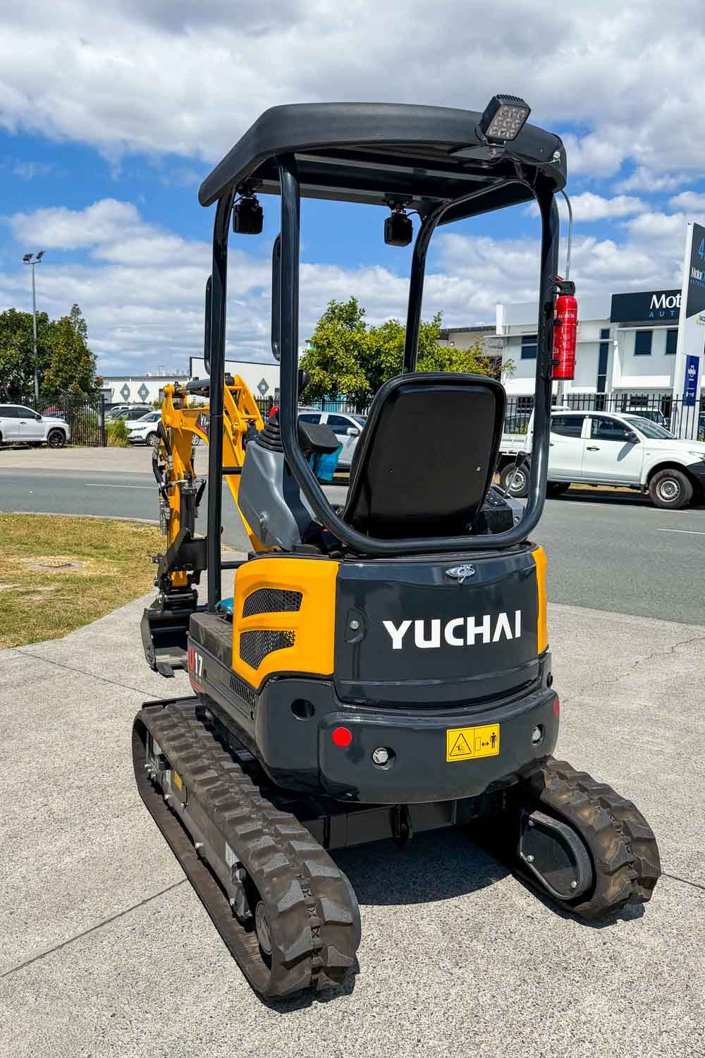 Rear view of the Yuchai mini excavator showing the ROPS canopy, rubber tracks and rear counterweight